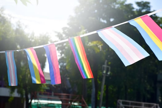 Lgbtq flags were hung on wire to decorate outside balcony of restaurant, soft and selective focus, concept for LGBTQ plus gender celebrations in pride month around the world. photo