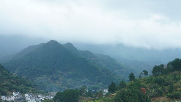The beautiful traditional Chinese village view with the classical architecture and fresh green trees as background photo