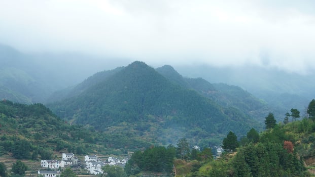 The beautiful traditional Chinese village view with the classical architecture and fresh green trees as background photo