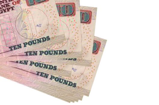 10 Egyptian pounds bills lies in small bunch or pack isolated on white. Mockup with copy space. Business and currency exchange photo