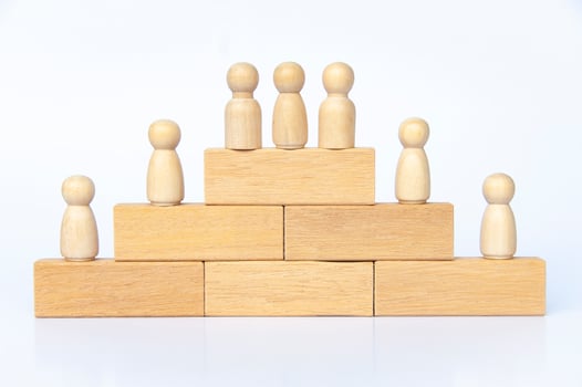Goal achievement and winner concept. Wooden people figure on top of wooden blocks. Goal achievement, business growth and career progression. photo