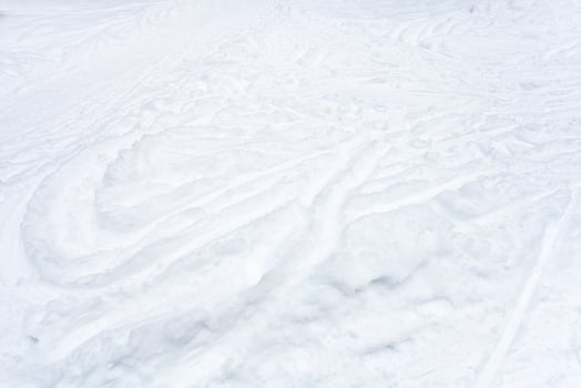 snowfield with ski runs and paths in snow photo