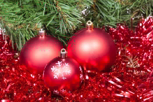 few red Christmas balls, tinsel and Xmas tree photo