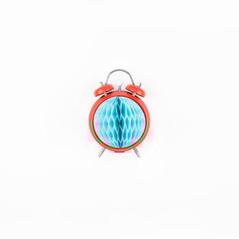 Red alarm clock with blue paper ball concept photo