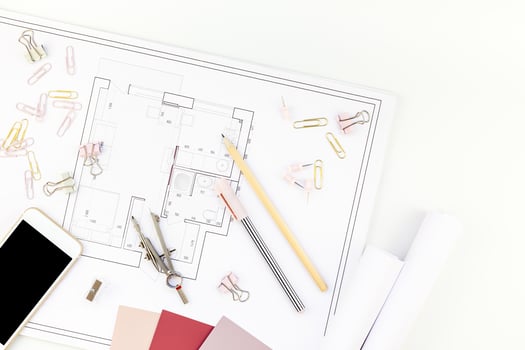 Interior designer table workplace with house plan photo