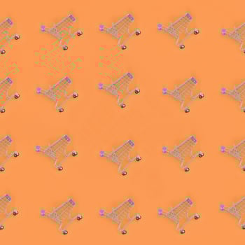 Shopping addiction, shopping lover or shopaholic concept. Many small empty shopping carts perform a pattern on a pastel colored paper background. Flat lay composition, top view photo