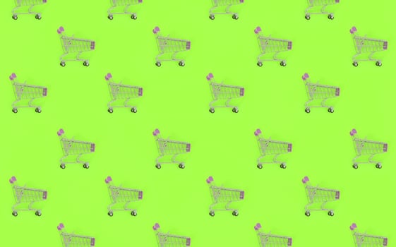 Shopping addiction, shopping lover or shopaholic concept. Many small empty shopping carts perform a pattern on a pastel colored paper background. Flat lay composition, top view photo