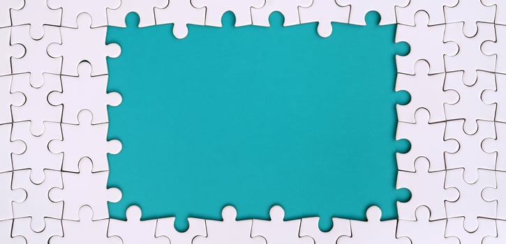 Framing in the form of a rectangle, made of a white jigsaw puzzle around the blue space photo