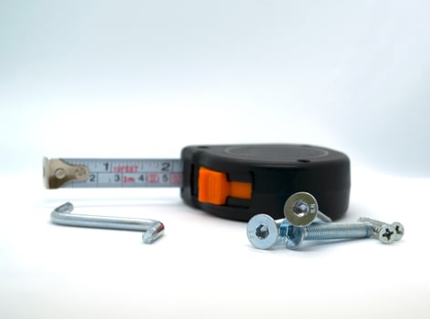 Nails, hex screwdriver and construction ruler photo