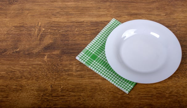Top view of clean empty plate on wooden tabletop photo