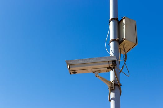 road Security camera on blue sky background photo