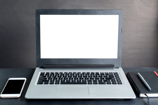 Laptop, smartphone, notebook, pen, on black wooden table with black background photo