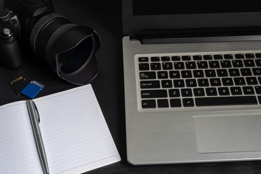 Top view laptop, camera, notebook, pen, memory card photo