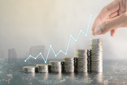 Double exposure hand stacking coins on blur background of city with profit line chart growth up. Business, finance, marketing, e-commerce concept and design photo
