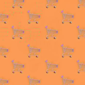 Shopping addiction, shopping lover or shopaholic concept. Many small empty shopping carts perform a pattern on a pastel colored paper background. Flat lay composition, top view photo