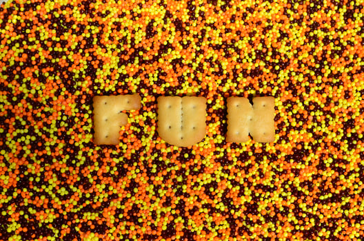 Fun. The word from the edible letters lies on the glazed powder photo
