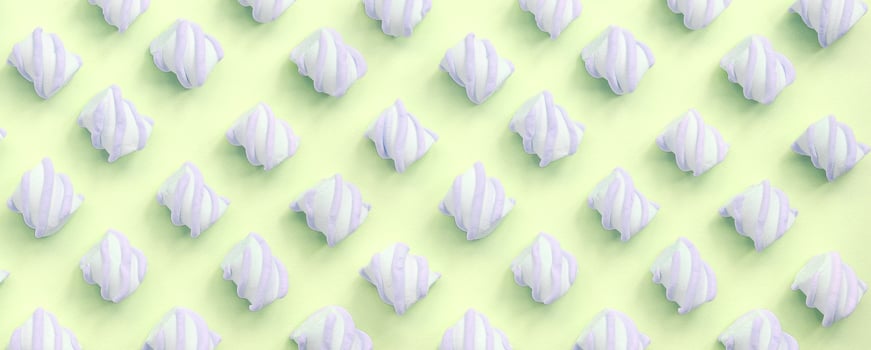Colorful marshmallow laid out on lime paper background. pastel creative textured pattern photo