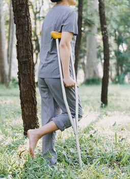 young asian physical therapist working with senior woman on walking with a walker photo