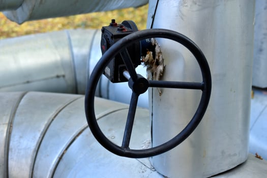 Black iron valves on the water heating main. Valves on heating pipes in the city. photo