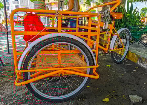 Playa del Carmen Quintana Roo Mexico 2022 Orange tricycle bike in Playa del Carmen Mexico. photo