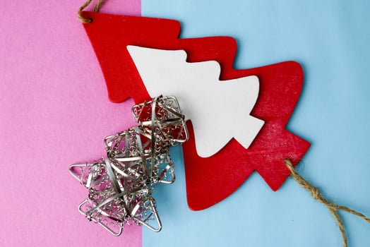 Festive New Year Christmas winter happy blue and pink beautiful joyful background with thinking little wooden and metal toy homemade tree. Flat lay. Top view. Holiday decorations. photo