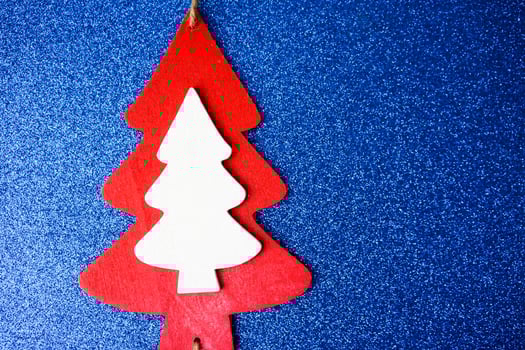 Festive New Year Christmas winter happy beautiful blue glitter glitter background with a small toy wooden homemade cute Christmas tree. Flat lay. Top view. Holiday decorations photo