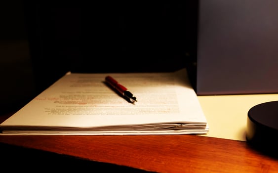 blur proofreading paper on table photo
