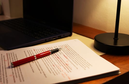 blur proofreading paper on table photo
