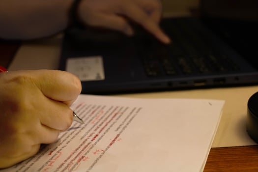 blur proofreading paper on table photo