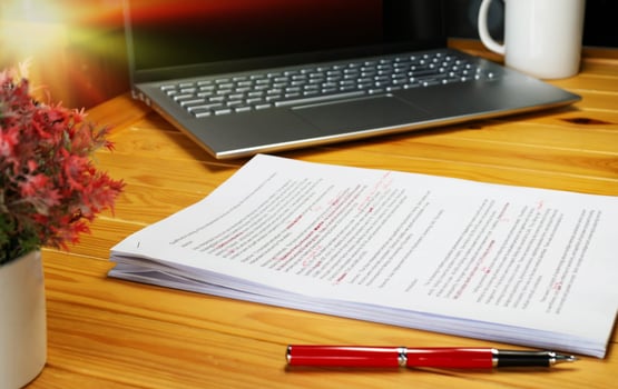 proofreading paper on table photo