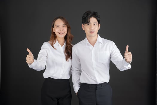 Two young businessmen raising their thumbs forward. photo