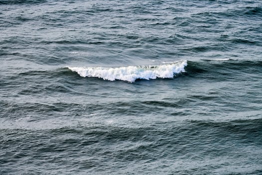 Deep blue sea waters splashing with foamy waves, dark blue wavy ocean water surface, stormy sea photo