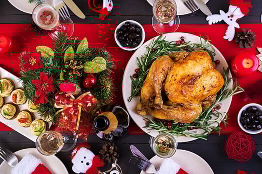 Baked turkey. Christmas dinner. The Christmas table is served with a turkey, decorated with bright tinsel and candles. Fried chicken, table.  Family dinner. Top view photo