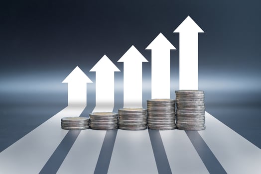 Stack of coins on black table with arrow graph growth up photo