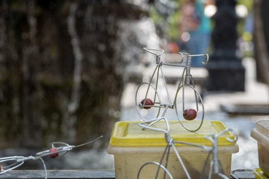artisan on the street making bicycle figurines with wire, handmade metal figurines mexico photo