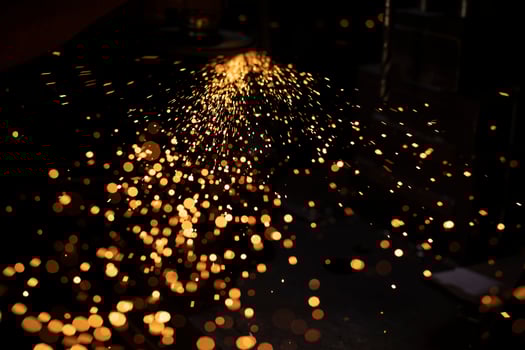 Sparks from grinding metal. Bright lights in dark. Cutting steel. Metal profile processing. photo