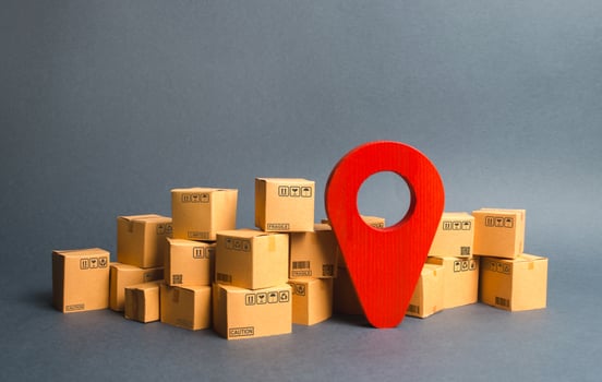 Lots of cardboard boxes and a red position pin. Locating packages and goods. Algorithm for constructing a minimum route for the delivery of orders. Logistics transportation, storage warehouse. photo