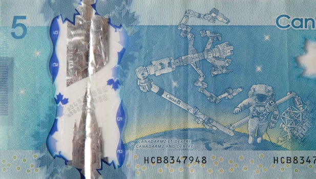 Dextre and canadarm2 on Canada 5 Dollars 2013 Polymer Banknote fragment photo