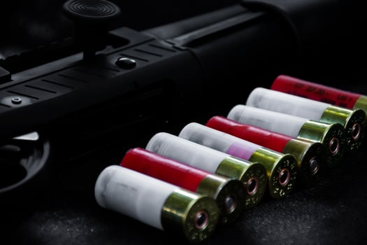 Shotshell bullets near shotgun, soft and selective focus. photo