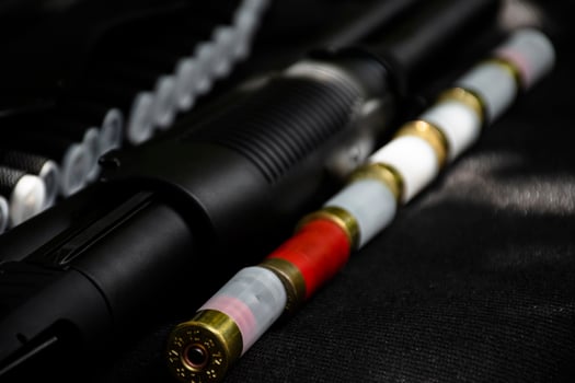 Shotshell bullets near shotgun, soft and selective focus. photo