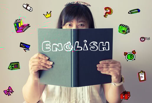 Thai girl holding book with illustrations flying around her photo