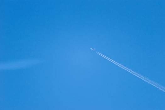 trace of an airplane in the blue sky photo