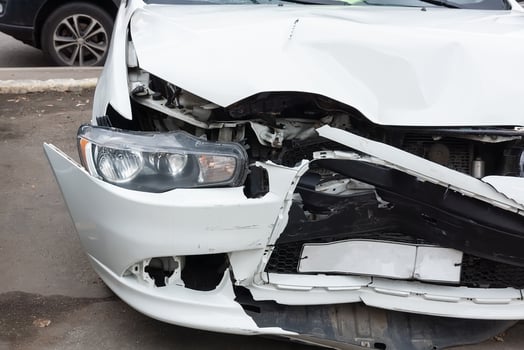 Front of black car get damaged by accident on the road photo