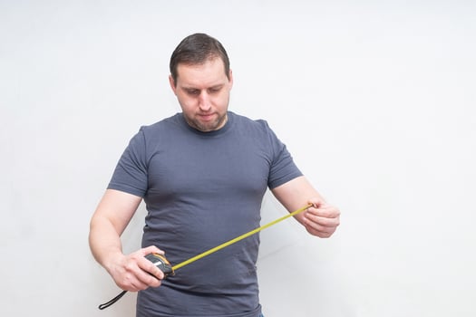 a man with a centimeter on a white background photo