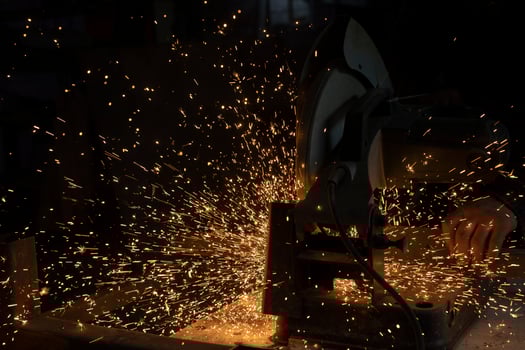 Sparks from metal. Cutting steel. Saw spins quickly. Industrial background. photo