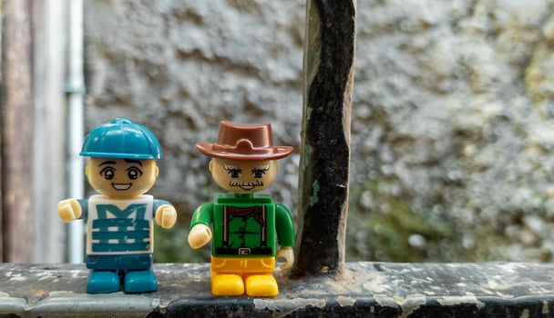 October 2022, Jakarta Indonesia, minifigure toy against a background of a blurred wall and a wooden fence in the sun photo