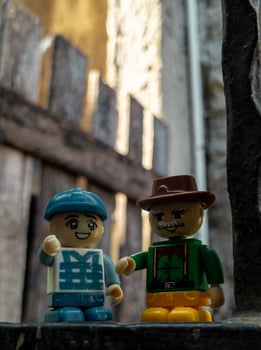 October 2022, Jakarta Indonesia, minifigure toy against a background of a blurred wall and a wooden fence in the sun photo