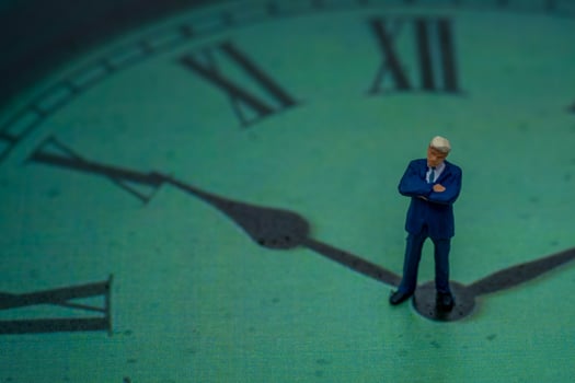 Miniature People Business man thinking a problem for solve problem on center a clock photo