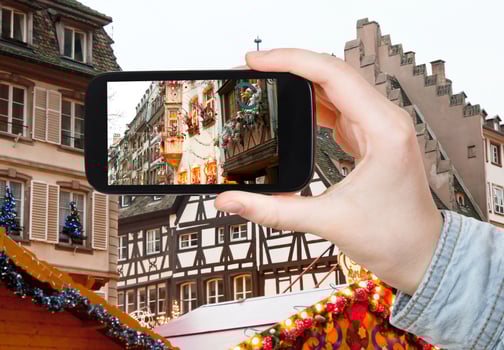 tourist takes photo Christmas decoration