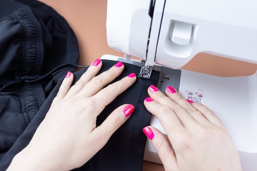 Hands on the sewing machine photo